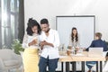 smiling african american business people using smartphone together Royalty Free Stock Photo