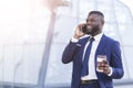 Smiling African American Businessman Chatting On Phone Having Coffee Outdoors Royalty Free Stock Photo