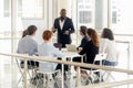 African American male coach make flip chart presentation for employees Royalty Free Stock Photo