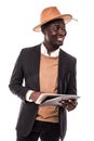 Smiling african american businessman using tablet wearing in suit and hat . Young man in suit working with portable computer, isol Royalty Free Stock Photo