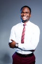 Smiling african american businessman in white shirt and tie looking at camera with arms crossed Royalty Free Stock Photo