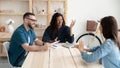 Smiling african american businesswoman and businessman with resume interviews woman. Royalty Free Stock Photo