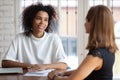 Smiling African American businesswoman hr manager holding interview with applicant Royalty Free Stock Photo