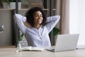 Smiling African American businesswoman relaxing stretching in comfortable office chair Royalty Free Stock Photo