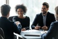 Smiling African American businesswoman shaking business partner hand at meeting