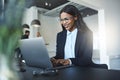 Smiling African American businesswoman using a laptop at her des Royalty Free Stock Photo