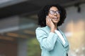 Smiling African American businesswoman using mobile phone against building Royalty Free Stock Photo