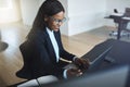 Smiling African American businesswoman working online at her off Royalty Free Stock Photo