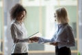 Smiling diverse businesswomen shake hands greeting in office