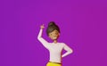 Smiling African American character girl finger points empty space advertisement design on purple background 3D rendering