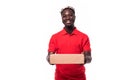 Smiling african american delivery man holding cardboard box and looking at camera isolated on white background Royalty Free Stock Photo