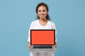 Smiling african american doctor woman isolated on blue background. Doctor in medical gown holding laptop pc computer Royalty Free Stock Photo