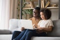 Smiling African American father with little daughter using laptop together Royalty Free Stock Photo