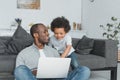 smiling african american father and son using laptop together Royalty Free Stock Photo