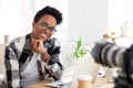 Smiling black millennial woman shooting at workplace Royalty Free Stock Photo