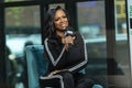 Smiling african american female speaking with a microphone at an interview