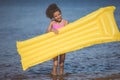 smiling african american girl holding inflatable mattress Royalty Free Stock Photo