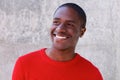 Smiling african american guy in red sweater looking away Royalty Free Stock Photo