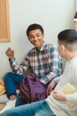 Smiling african american high school student talking to classmate during