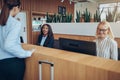 Smiling African American hotel concierge helping a guest check i Royalty Free Stock Photo