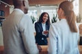 Smiling African American hotel concierge helping guests during c Royalty Free Stock Photo