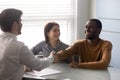 Smiling african american husband shaking hands with businessman. Royalty Free Stock Photo