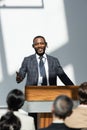 smiling african american lecturer pointing with Royalty Free Stock Photo