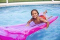 Smiling African American little boy playing in the swimming pool with an inflatable raft. Royalty Free Stock Photo