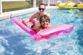 Smiling African American little boy playing in the swimming pool with an inflatable raft. Royalty Free Stock Photo