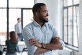 Smiling biracial male employee look in distance pondering Royalty Free Stock Photo