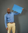 Smiling, african american male voter holding a copyspace board sign on public opinion message. Casual and positive man