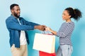 smiling african american man giving shopping