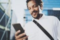 Smiling African American man in headphone making video call via smartphone in hand.Concept of guy using Internet-enabled Royalty Free Stock Photo