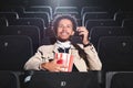 Smiling african american man holding popcorn Royalty Free Stock Photo