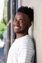 Smiling african american man leaning against wall Royalty Free Stock Photo