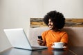 Smiling african american man sitting at table with mobile phone Royalty Free Stock Photo