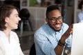 Smiling African American man talking with female colleague Royalty Free Stock Photo