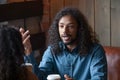 Smiling African American man talking to girlfriend in cafe Royalty Free Stock Photo