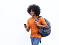 Smiling african american man walking with bag and cellphone Royalty Free Stock Photo