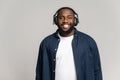 Smiling African American man in wireless headphones looking at the camera Royalty Free Stock Photo