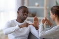 Smiling African American man and woman speaking sign language