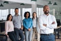 Smiling African American manager and his team in an office Royalty Free Stock Photo