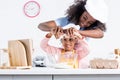 smiling african american mother and daughter in chef hats putting eggs into bowl together Royalty Free Stock Photo