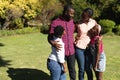 Smiling african american parents with daughter and son standing embracing outdoors Royalty Free Stock Photo