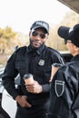 Smiling african american police officer with Royalty Free Stock Photo