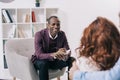 Smiling african american psychiatrist talking to Royalty Free Stock Photo