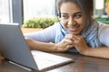 Smiling African-american woman with headset in front of laptop monitor. Royalty Free Stock Photo