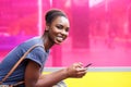 Smiling african american woman holding mobile phone Royalty Free Stock Photo