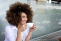 Smiling african american woman sitting with cup of coffee Royalty Free Stock Photo