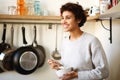 Smiling african american woman standing in kitchen eating breakfast cereal Royalty Free Stock Photo